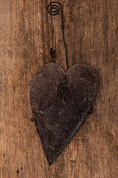 Rusty heart on wooden background