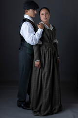 A working class Victorian couple standing together against a studio backdrop