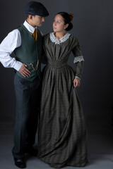 A working class Victorian couple standing together against a studio backdrop