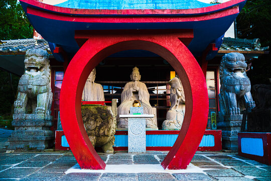 statues behind a temple gate