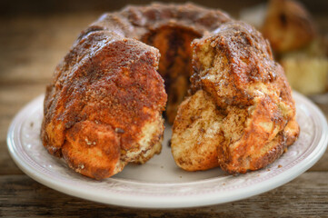 Pie "Monkey bread" with cinnamon on a wooden background.