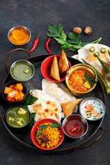 Indian Thali on dark background.