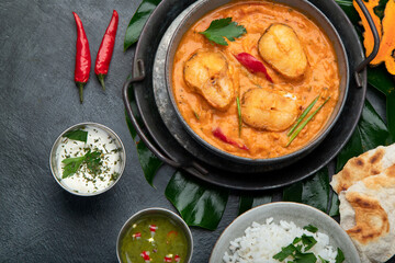 Kerala fish curry on dark background.