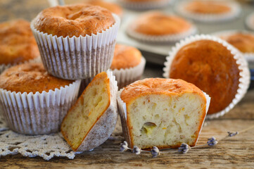 Homemade muffins. Muffins in baking molds. Muffins on a wooden background.