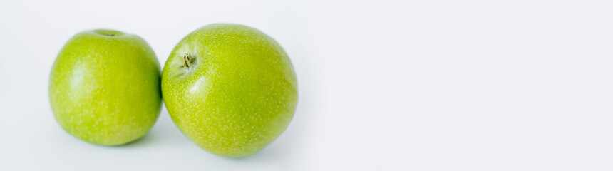 green and ripe apples on white, banner.