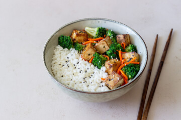 Rice with tofu, broccoli, carrots and sesame. Bowl. Healthy eating. Vegetarian food.