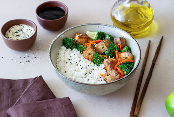Rice with tofu, broccoli, carrots and sesame. Bowl. Healthy eating. Vegetarian food.