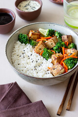 Rice with tofu, broccoli, carrots and sesame. Bowl. Healthy eating. Vegetarian food.