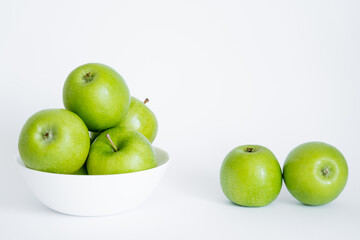 bowl with green and fresh apples on white.