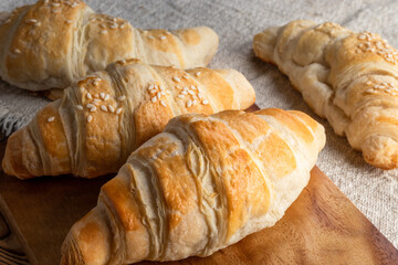 Freshly baked croissants on wooden background. Homemade croissants