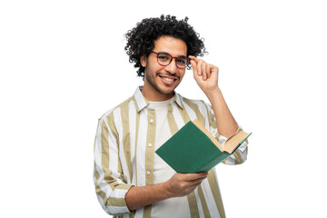 education, vision and people concept - happy smiling young man in glasses reading book over white...