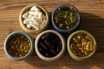 different vitamins and dietary supplements on a white plate, omega and vitamin d3