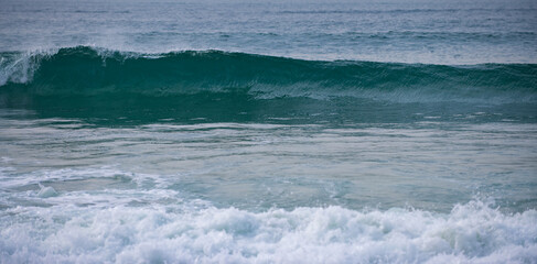 Blue ocean wave, ocean waves, natural background. Blue clean wavy sea water. Sea foam.