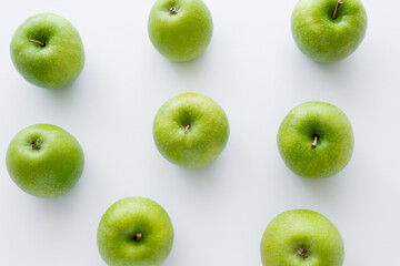 flat lay of green and fresh apples on white.