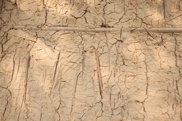 Abstract image of brown clay wall with bamboo grunge texture background for interior decoration.