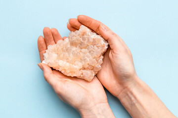 Natural crystal mineral stone in hands. Crystal texture closeup