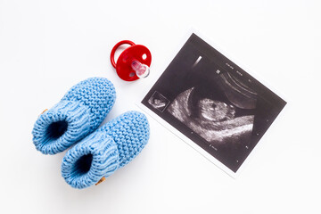 Pregnancy background. Baby accessories with ultrasound picture of unborn baby