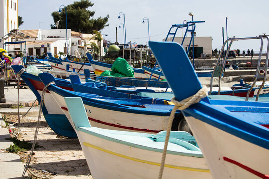 evocative close-up image of the bow of a boat
boats moored in the harbor in a small
fishing village in Sicily, Italy