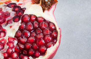 Pomegranate broken open with pips on a grunge surface with copy space