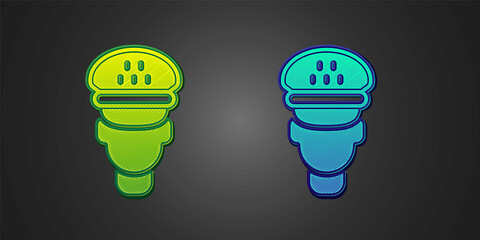 Green and blue Taxi driver icon isolated on black background. Vector