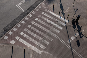 Pedestrian crossing on the road from the cobblestones.