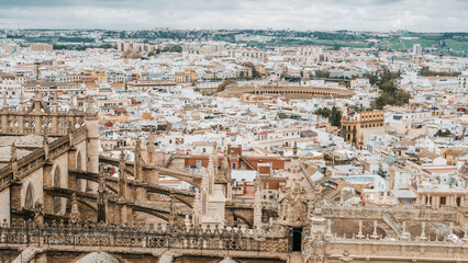Obraz premium aerial view of old quarter of Seville with bullring and Triana neighborhood in background on cloudy day