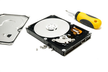 Open hard drive and screwdriver isolated on white background closeup. Computer hard drive HDD....