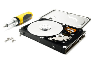 Open hard drive and screwdriver isolated on white background closeup. Computer hard drive HDD....