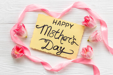 Happy Mothers day background with pink flowers, top view
