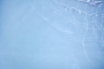 Transparent blue clear water surface texture with ripples, splashes and bubbles. Abstract nature...