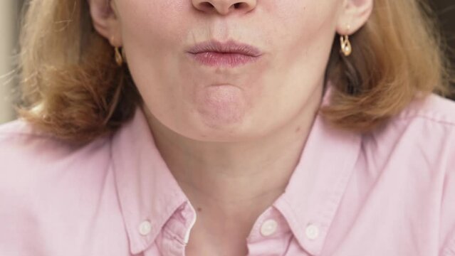 a woman collects saliva in a container for a dna test. 
