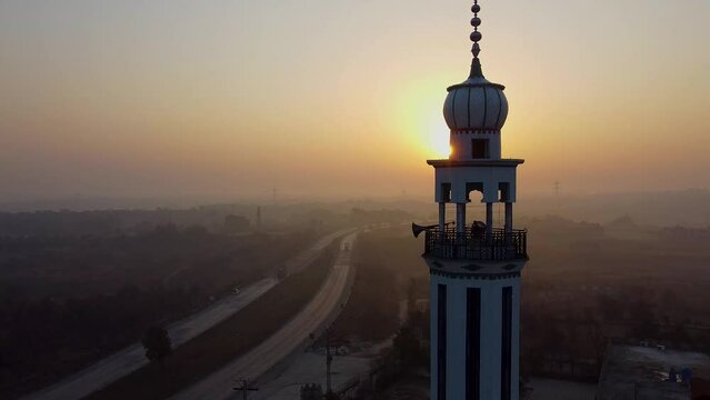 Sunrise sunset of road with traffic with minaret of Masjid in Pakistan