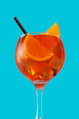 Glass of aperol spritz cocktail on blue background