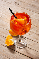 Glass of aperol spritz cocktail on wooden table