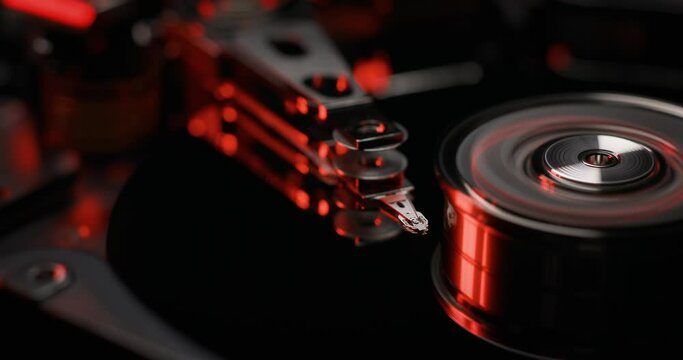 Macro shot of hard drive working with red light. Inside computer digital concept