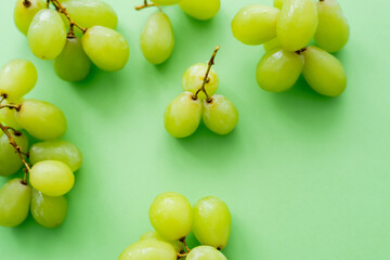 top view of delicious grapes on green.