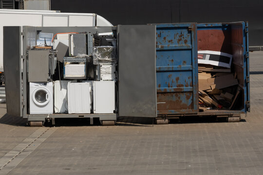 Electronic Waste For Recycling. Discarded Household Appliances In The Garbage Container