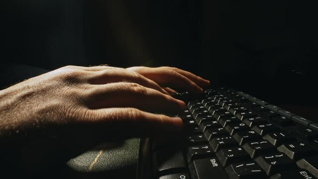 Man is typing on a keyboard.