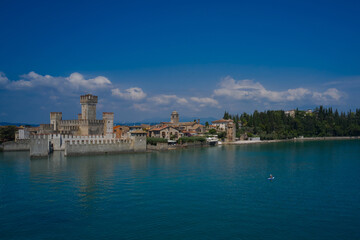 Sirmione, Lake Garda, Italy. The man on the sup board near the walls of the main castle of Sirmione