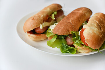 Hot dogs with sausage on a plate