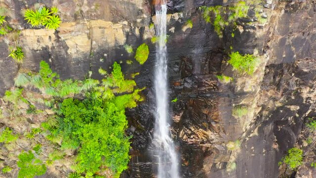 A beautiful waterfall in the mountains among the jungle. Bambarakanda Falls. Sri Lanka.