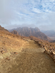 Sinai Mountain in cloudy  foggy day, Holy Mount Moses in Egypt, Sinai, Africa. Beautiful view from foot of the mountain. Sodt focus