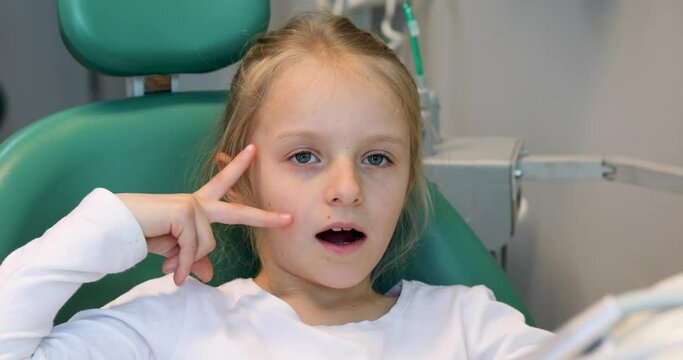little ukrainian girl in the dental office after tooth treatment