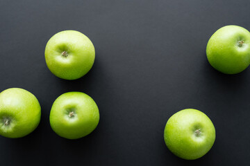 top view of healthy and green apples on black.