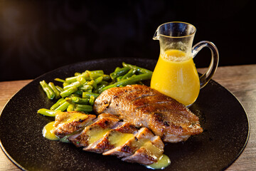 duck breast with string beans and orange sauce