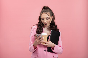 Portrait of shocked, puzzled girl in jacket reading post on social networking site using phone,...