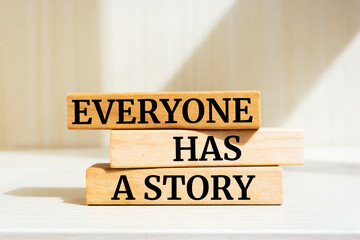 Everyone has a story text concept written on wooden blocks lying on a table