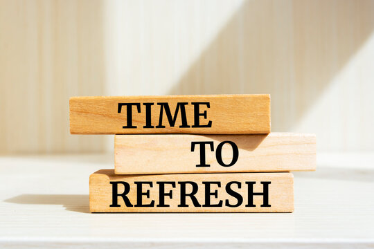 Wooden blocks with words 'TIME TO REFRESH'. Business concept