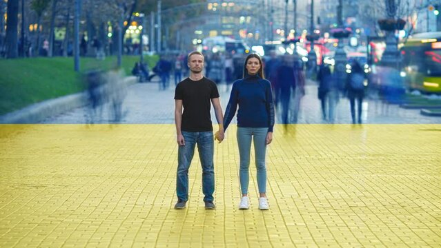 The couple stand on crowdy street on the ukrainian flag background. time lapse