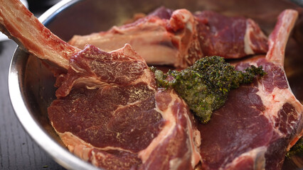 Raw marinated meat steaks in bowl